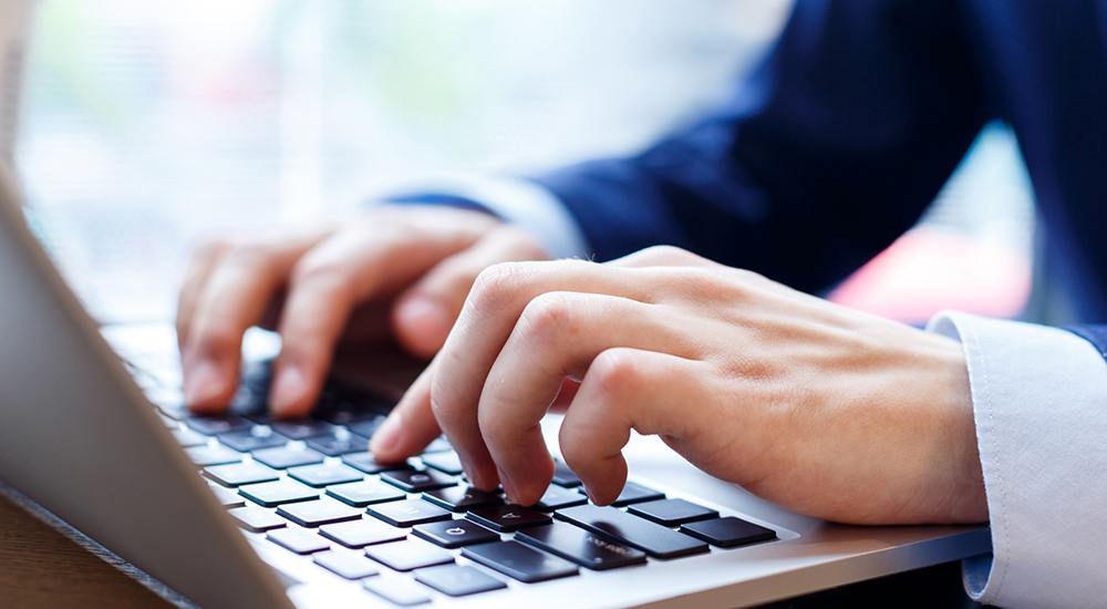 Man Typing on Computer